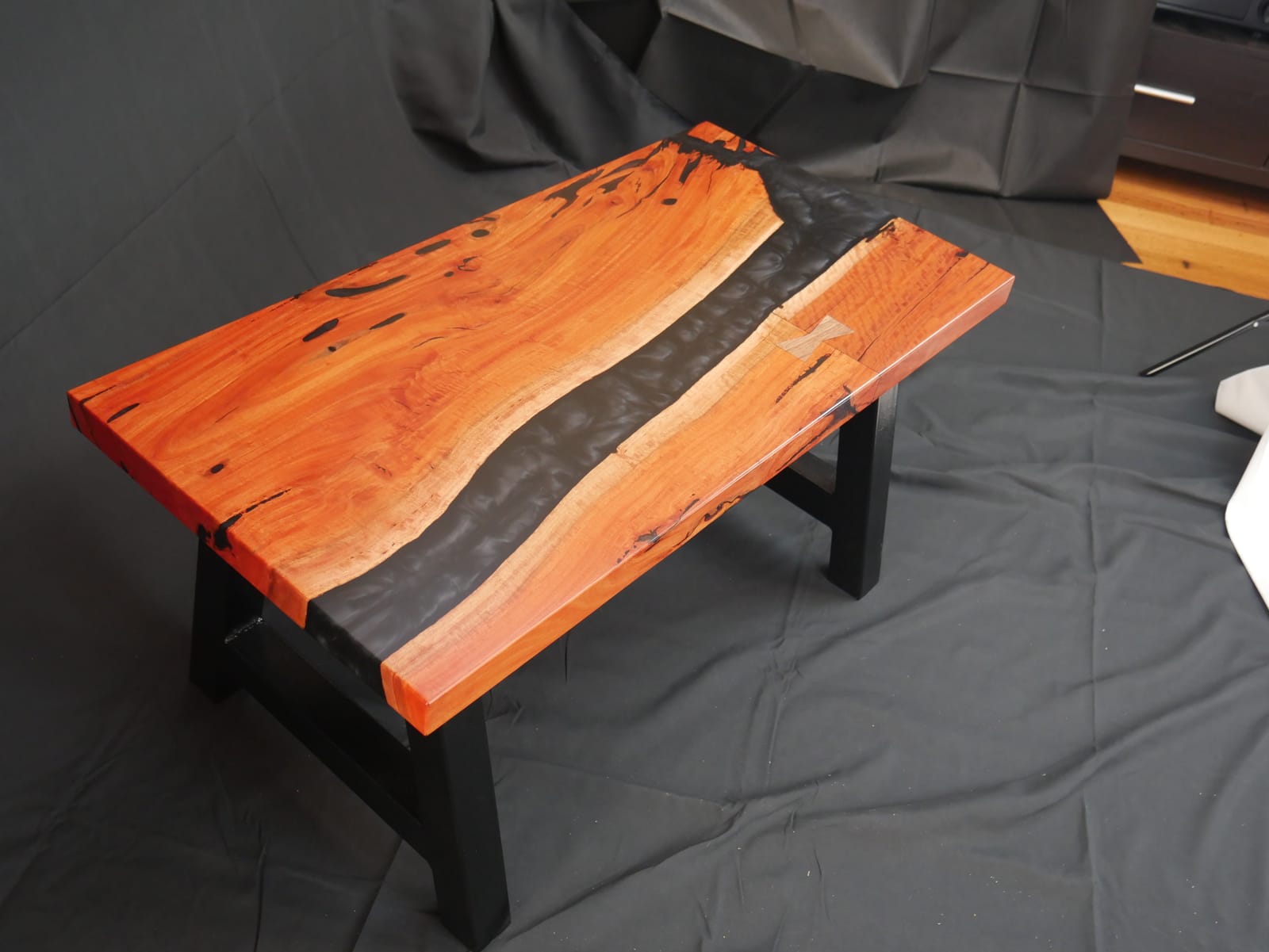 Redgum coffee table with black ebony resin swirls